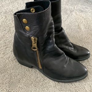 Black leather ankle boots with snaps and zippers